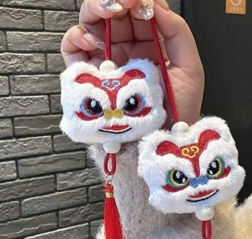 Handmade blue plush lion keychain with tassels and star stone decoration.