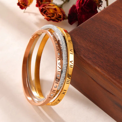 Titanium steel Roman numeral bracelet with gold plated carved design and diamond-embedded detail
