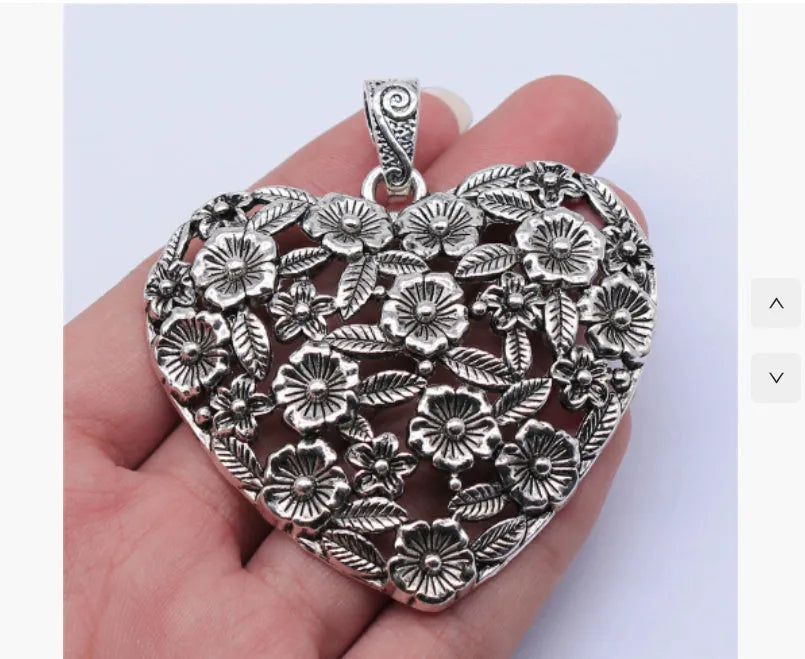 Hollow floral love pendant in ancient silver finish with European American styling