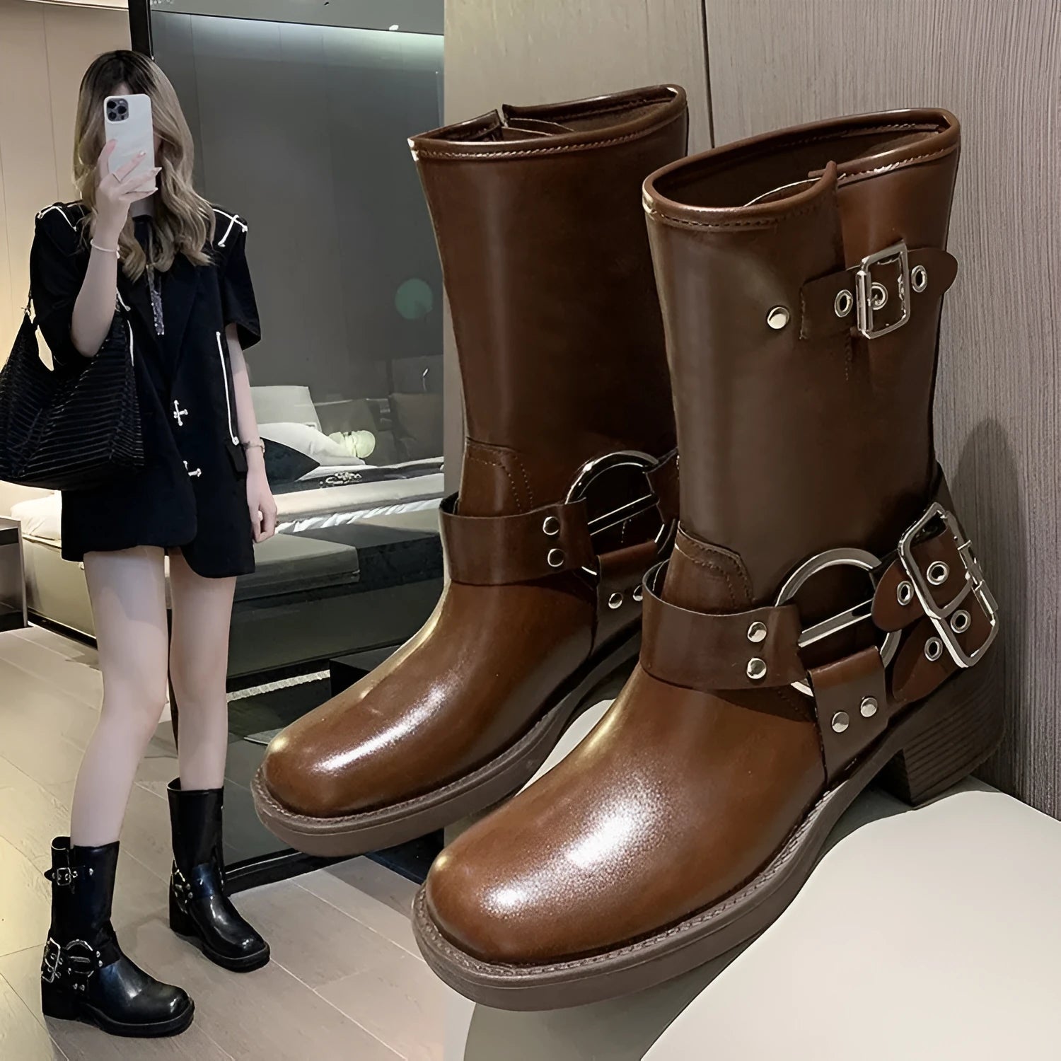 Women's black platform ankle boots with a silver buckle on the shaft, shown in a middle-calf length style.