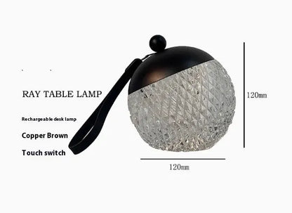 Small portable desk lamp with touch dimmer in gold finish, 12cm tall.
