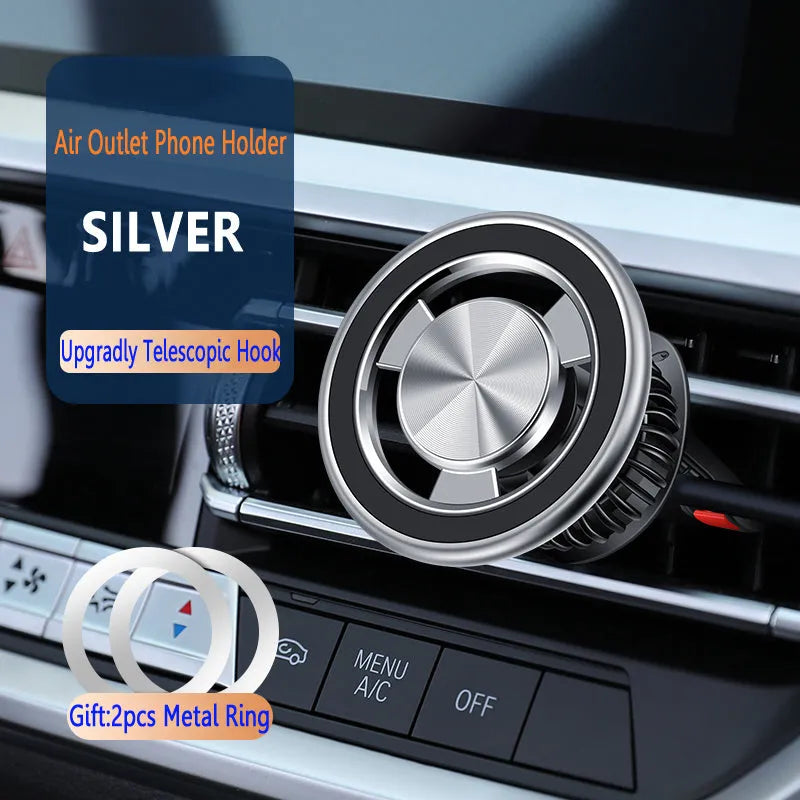 Silver magnetic car phone holder attached to a car air vent, showing a mobile phone secured to it.