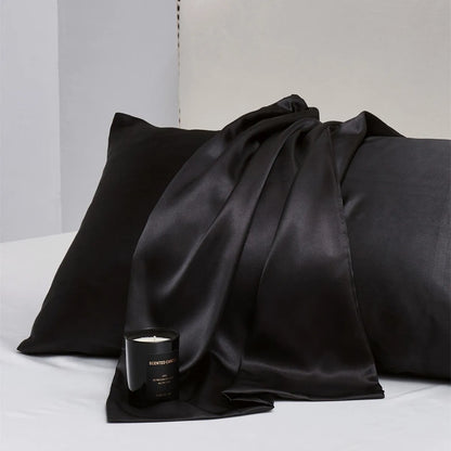 Pair of solid colour satin pillowcases showing smooth plain weave texture and reactive dye colour