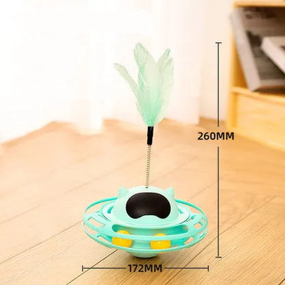 Pink self-hi tumbler cat toy with plush element on a turntable base, next to a play stick.
