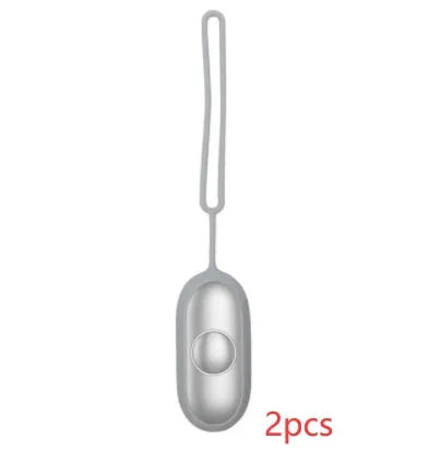 Hand-held micro-current sleep aid device in grey, green, or orange with round button and USB charging port