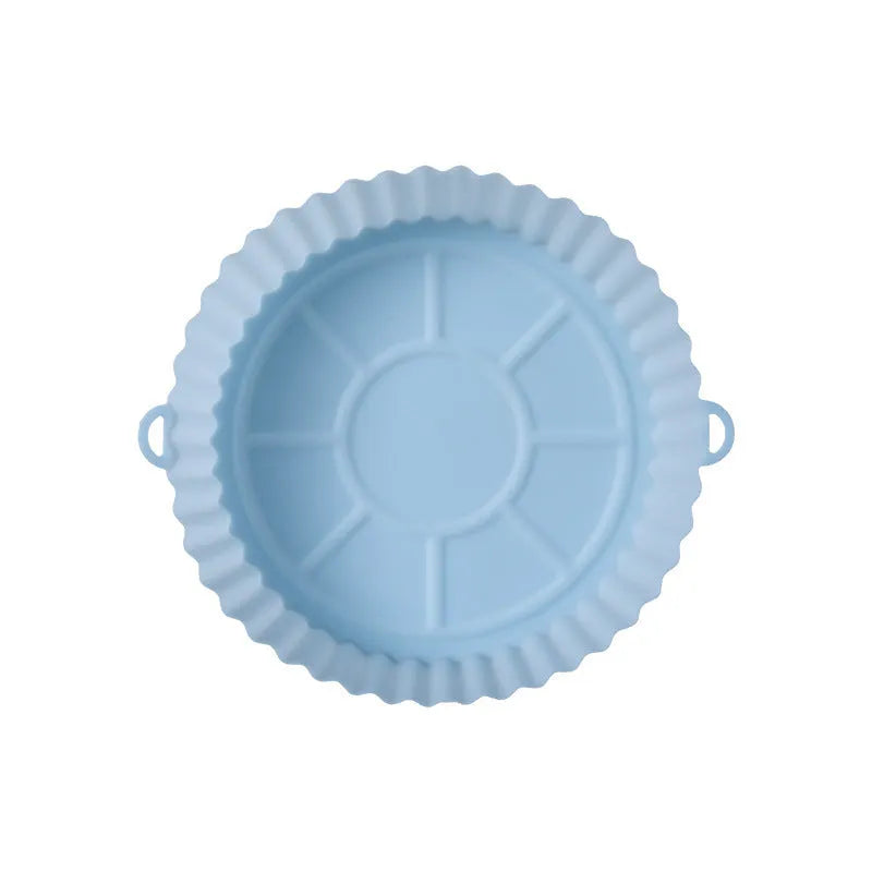 Round blue silicone baking tray mat with 4.5cm sides on a kitchen counter.