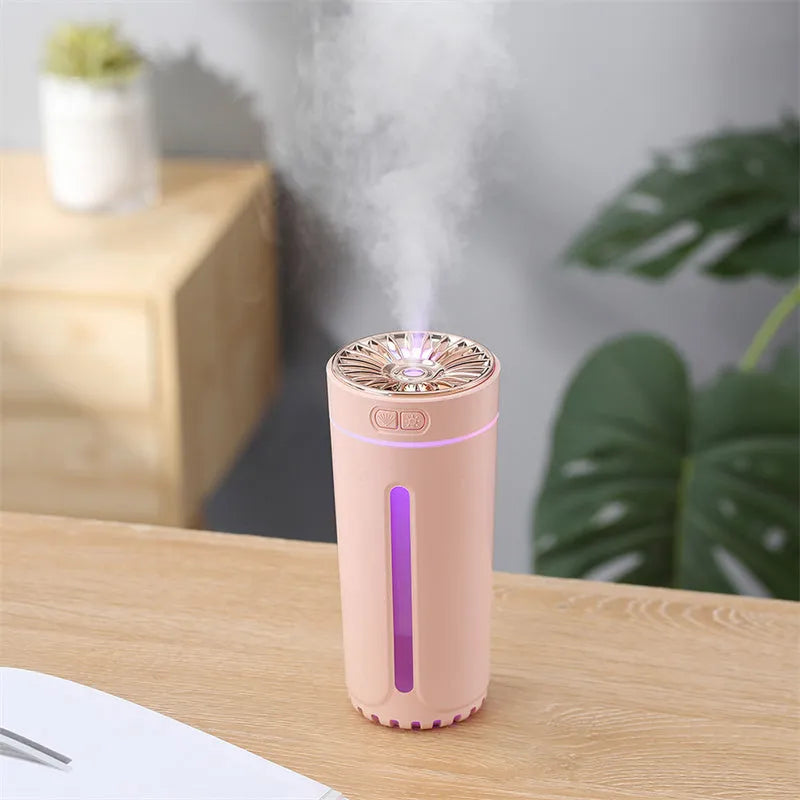 Black portable humidifier with LED lights beside car cup holder showing mist output