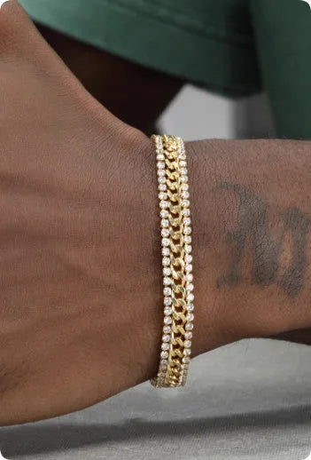 Gold-coloured titanium steel tennis bracelet with artificial gemstone inlay on a wrist.