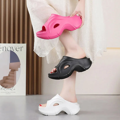 Women's white thick-soled EVA slippers with a round toe on a beach background.