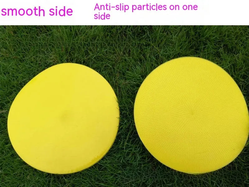 Soft yellow TPE football training landmark pad disc on grass, 23cm diameter.