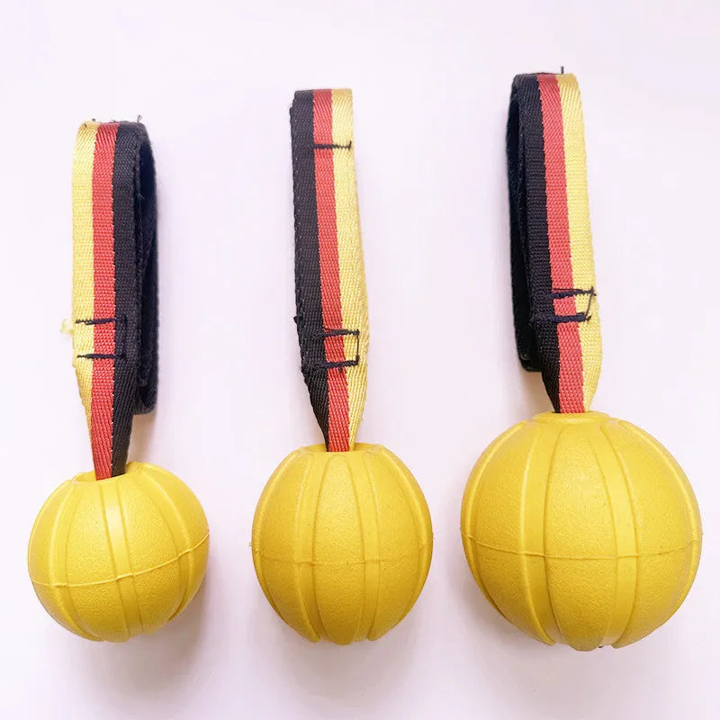 Yellow and camouflage coloured EVA foam floating dog balls with strings in 6.5cm, 7cm, and 9cm sizes.