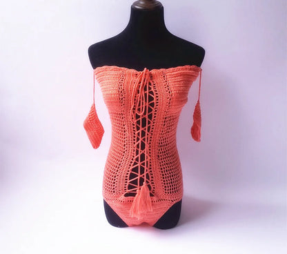 Off-shoulder one-piece swimsuit in aqua green on a mannequin, showing European/American cut and secure neckline.
