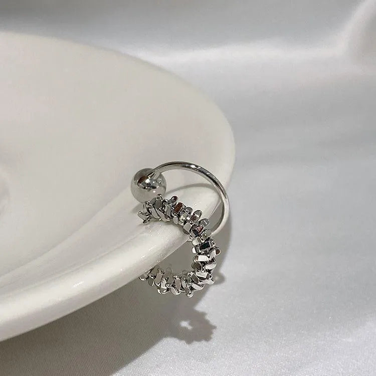 A pair of frosty-finish geometric clip-on earrings with an irregular abstract shape.