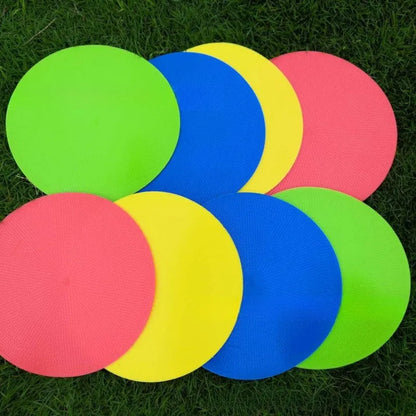 Soft yellow TPE football training landmark pad disc on grass, 23cm diameter.