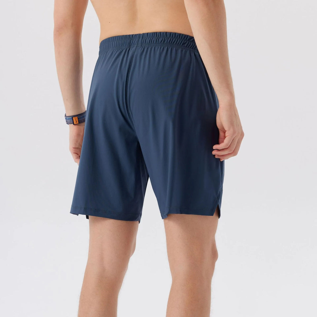 Men's black nylon sports shorts with mid-waist, shown flat.