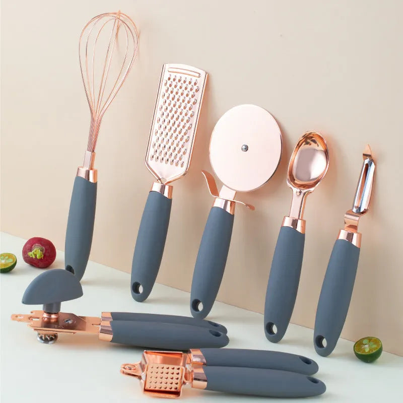 7-piece stainless steel kitchen tool set with copper finish on a countertop storage rack.
