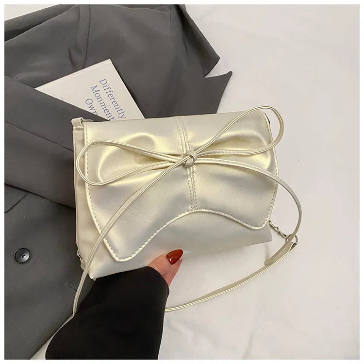 Black horizontal square PU crossbody bag showing internal mobile phone pocket and crossbody strap