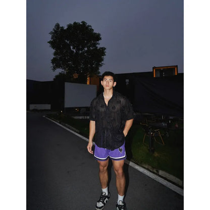 Men's loose fit floral print short sleeve shirt in black with a wool lining, shown on a mannequin.