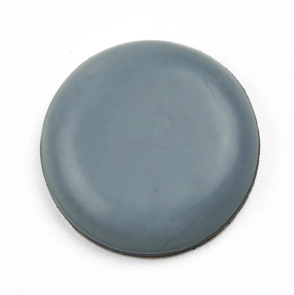 Blue grey 22mm adhesive slip pads attached to chair legs, preventing slides on hardwood floor, pack of 8