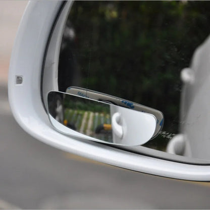 Glass adjustable blind spot rearview mirror with sponge adhesive backing for car installation.