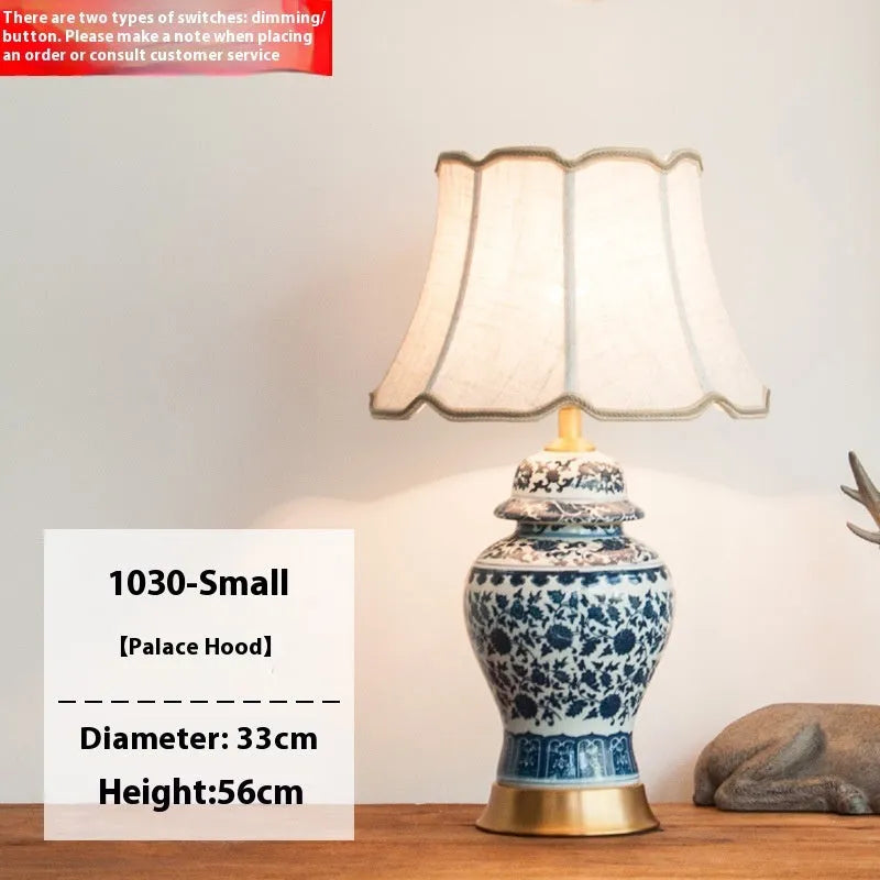 Chinese blue and white porcelain table lamp with cloth shade on bedside table