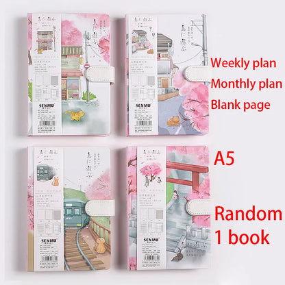 A5 wire-bound retro style notebook with colourful illustrated cover, shown with included pen.