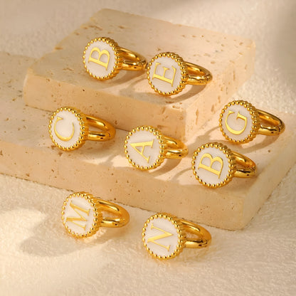 Round gold-tone letter earrings for women in stainless steel with electroplated finish, available in letters A to Z