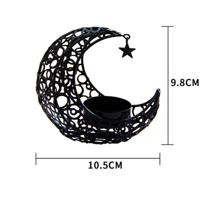 Metal crescent moon candle holder for tealight candles in black or gold colour on desktop