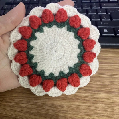 Handmade woven floral coaster in cotton and linen, showing pink, purple, red, and yellow colour options