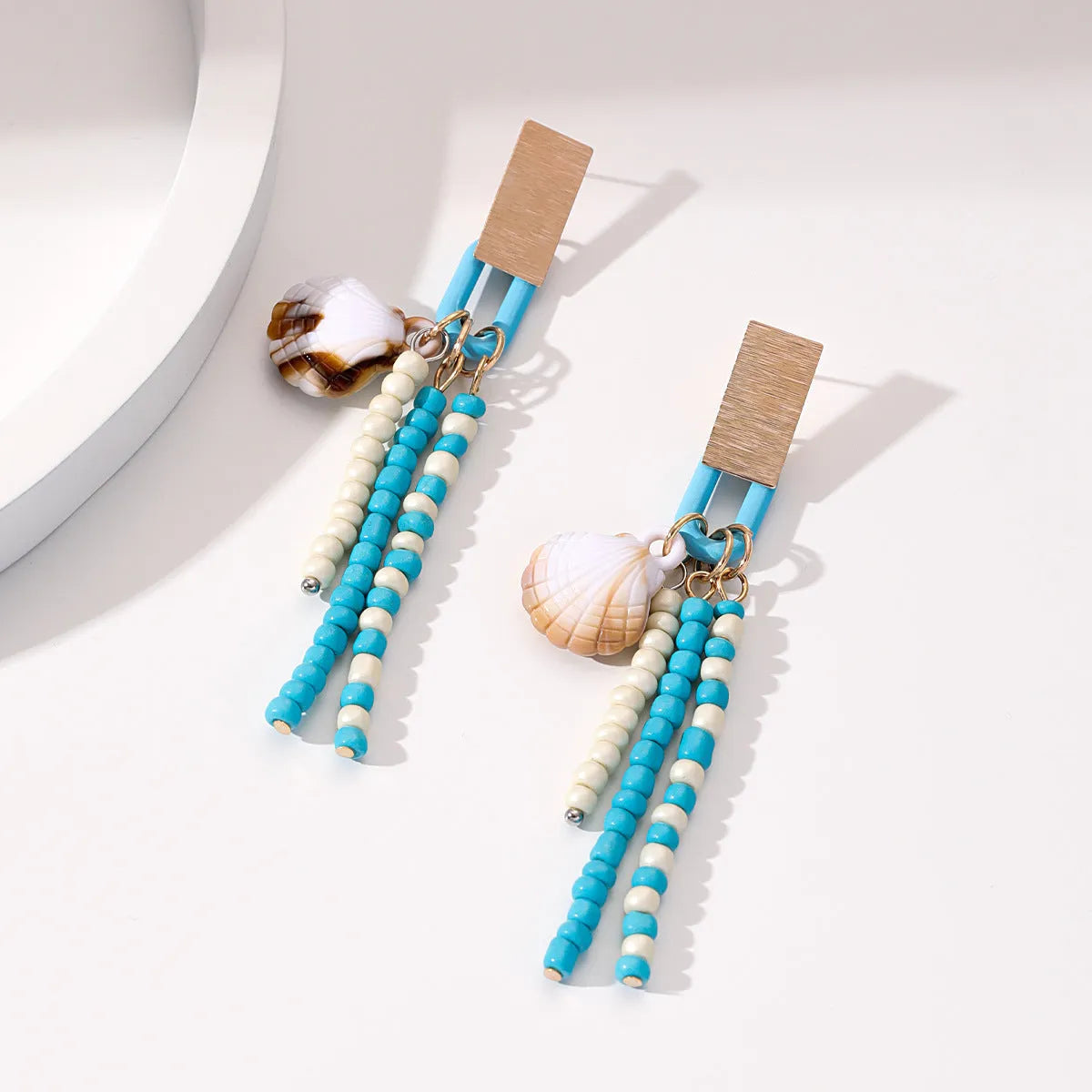 Handmade bohemian shell tassel earrings for women with colourful flower and geometric drop design