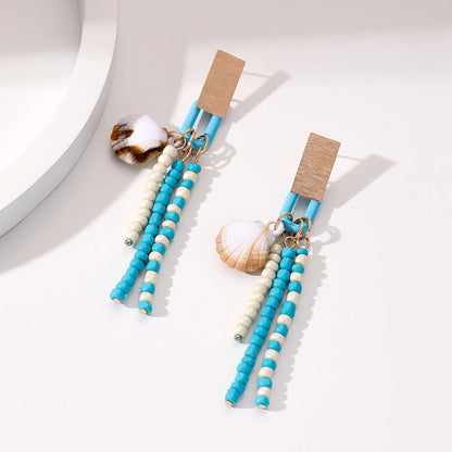 Handmade bohemian shell tassel earrings for women with colourful flower and geometric drop design