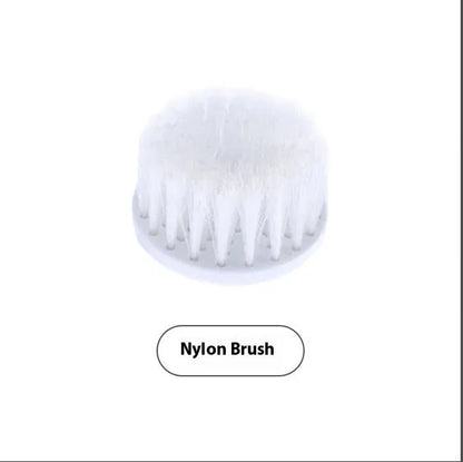 White cordless electric spin scrubber with multiple brush heads on a bathroom tile.