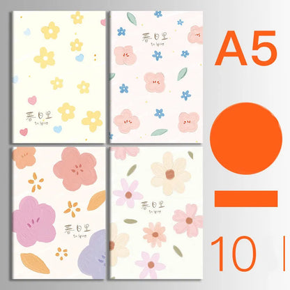 Pack of ten A5 kraft paper thread-bound notebooks with artistic cover designs lying flat.