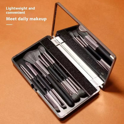 Portable makeup brush set with mirror showing artificial fibre brushes with silver handles