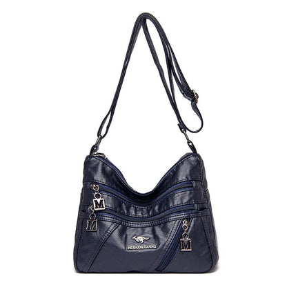 Middle-aged women's double layer PU shoulder bag with large capacity, welt pocket, and soft build in red, purple, dark blue, black, bronze, gray, or tan.