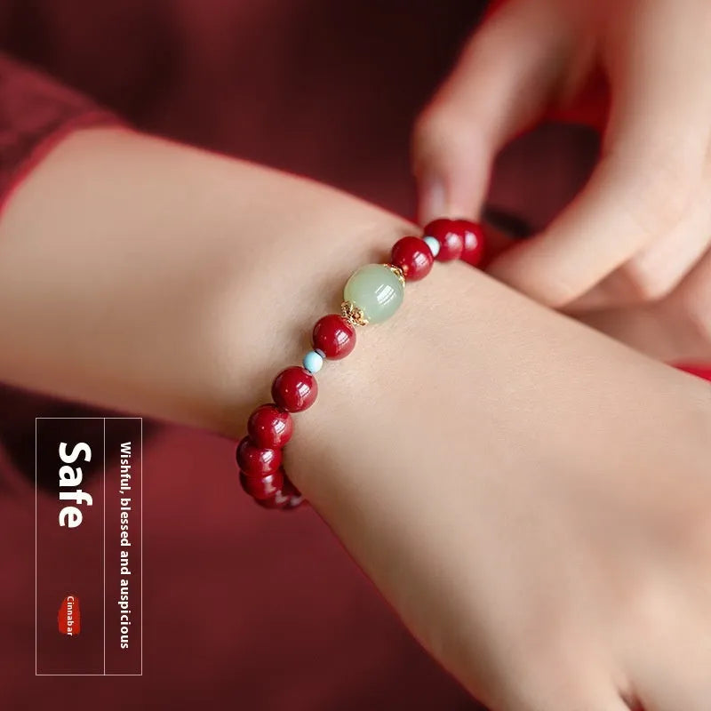 Purple Gold Sand cinnabar bracelet with geometric ellipse beads and a metal clasp on a wrist.