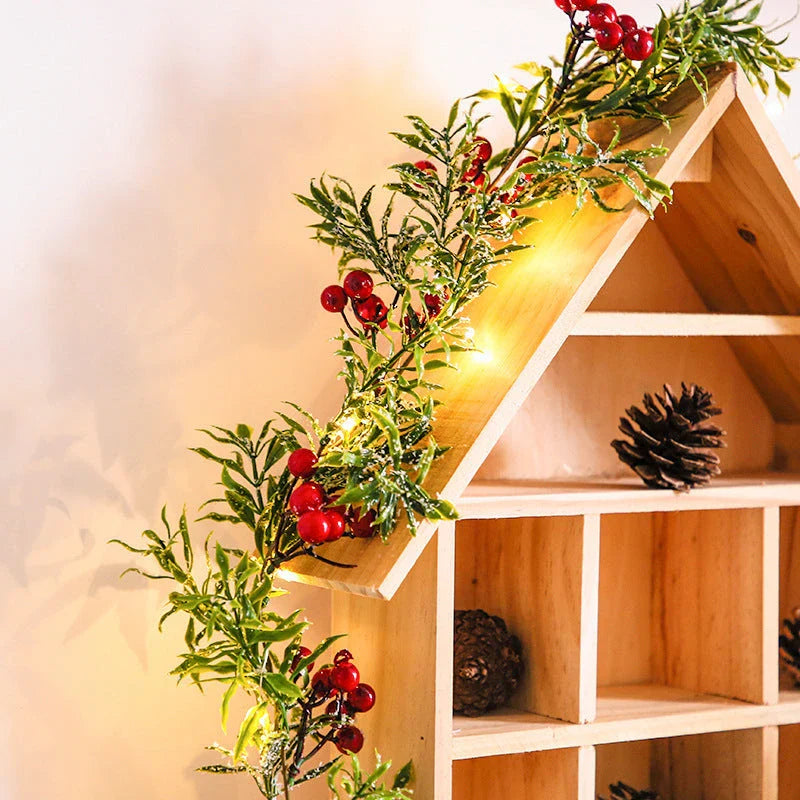 Festive Christmas fairy lights with leaf shapes and crimson berries, creating a warm, enchanting glow