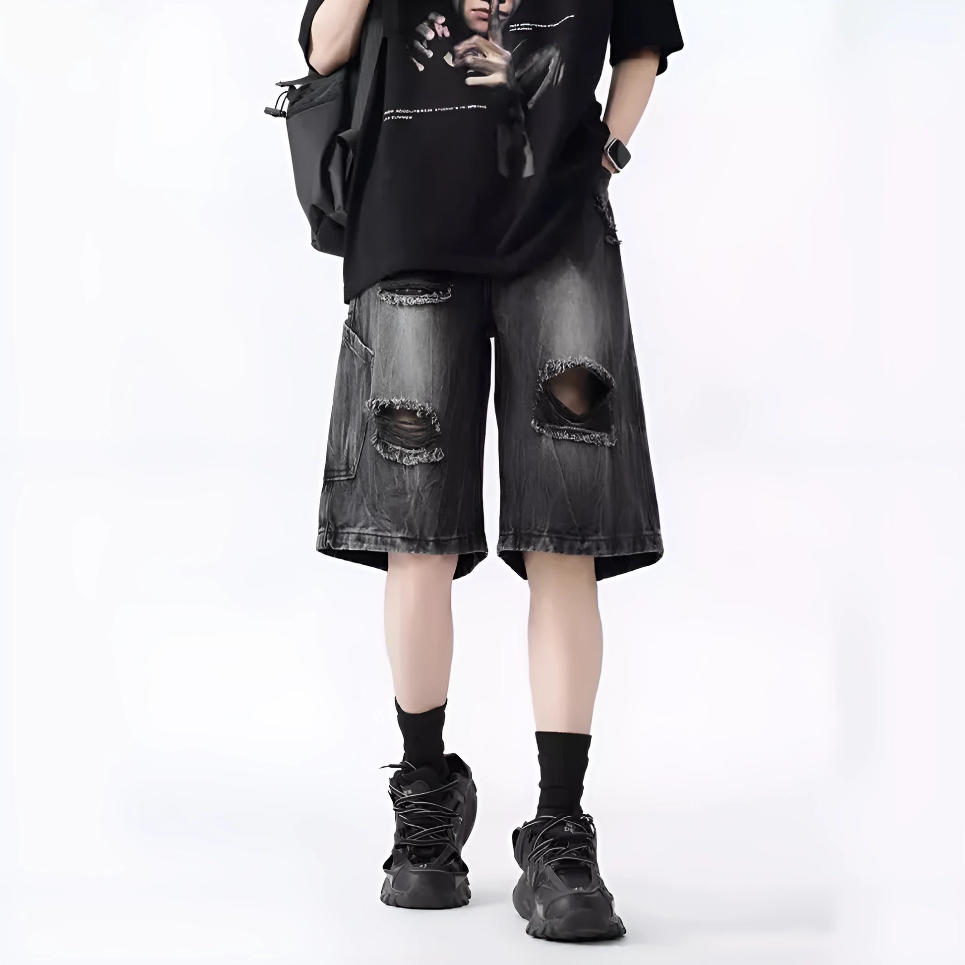 Mens loose fit ripped denim shorts in washed blue and black retro style