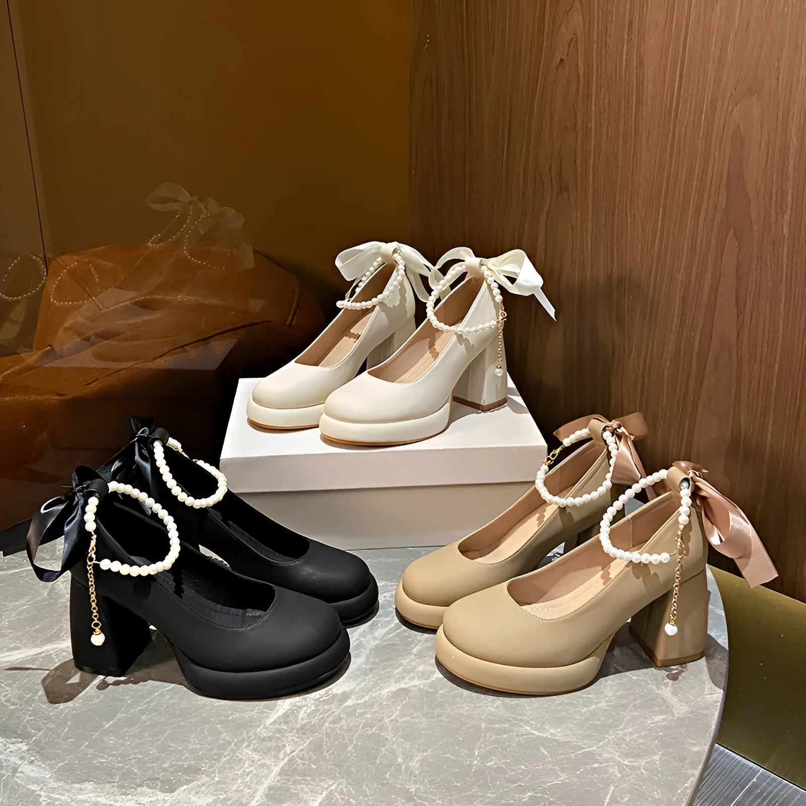 Women's beige preppy style Mary Jane shoes with chunky heel, ankle strap buckle, and pearl detail.