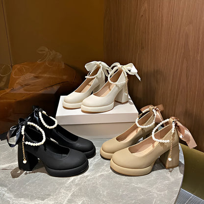 Women's beige preppy style Mary Jane shoes with chunky heel, ankle strap buckle, and pearl detail.
