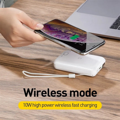 Small square black wireless charging power bank with LED display showing battery percentage.