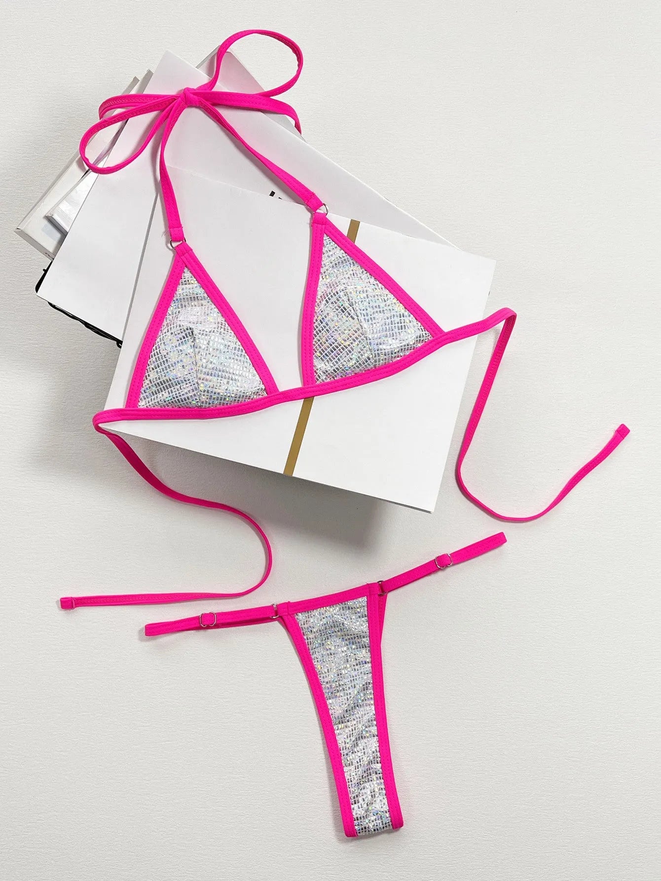 Silver solid colour women's triangle one-piece swimsuit with a split back on a mannequin.