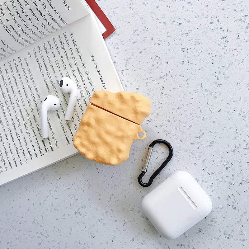 Green silicone AirPods case with raised cartoon animal design, showing charging port cutout.