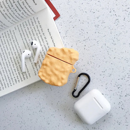 Green silicone AirPods case with raised cartoon animal design, showing charging port cutout.