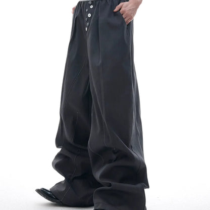 Straight-leg trousers with button-open line detail in black and grey colours, showing high-waist design and tailored silhouette