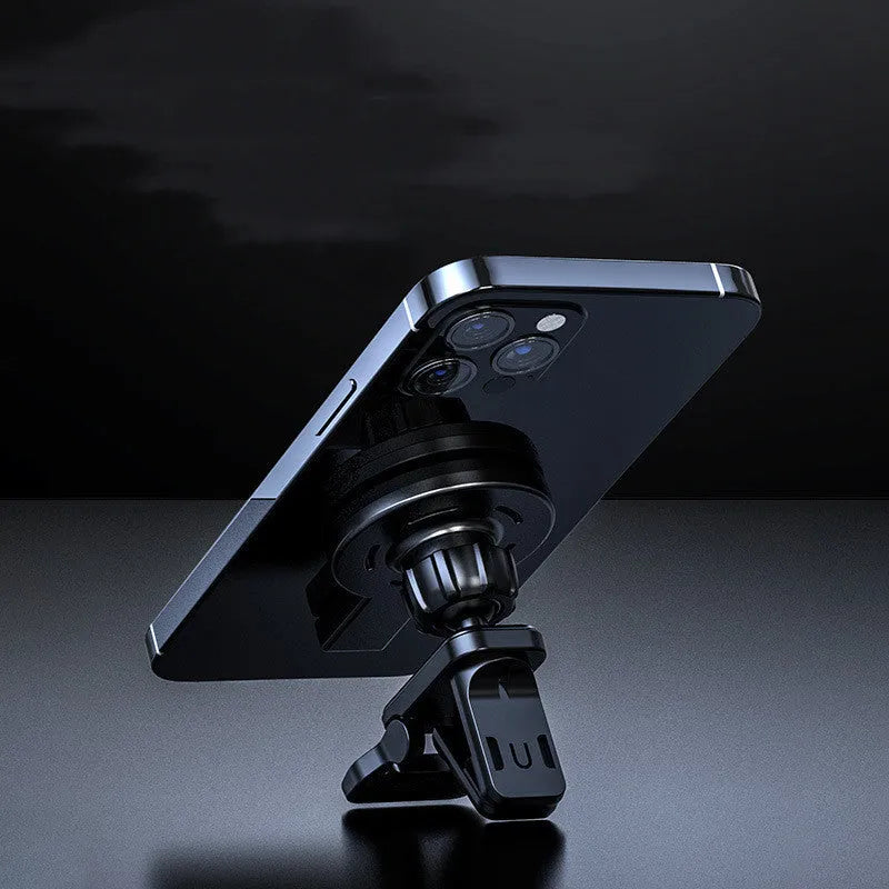 White and black magnetic wireless charging pad on a wooden table next to a smartphone.