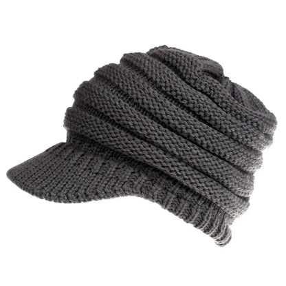 Women's acrylic knitted ponytail beanie in a solid colour, shown on a model with a ponytail.