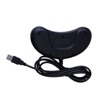 Black Sega USB PC game controller with 1.8m cable on a desk next to a laptop