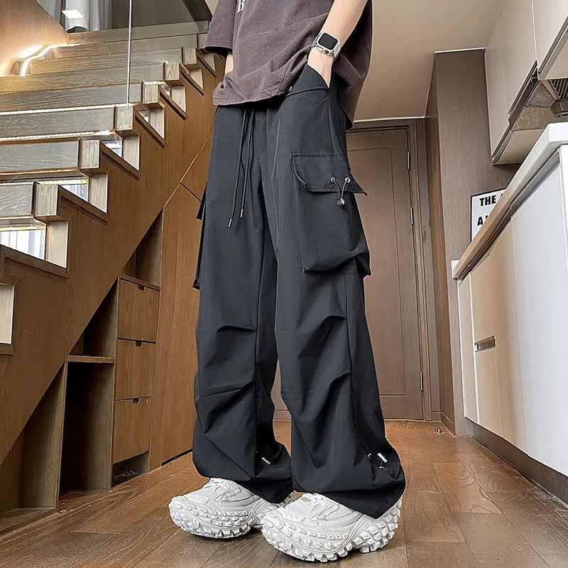 Plus size thin waterproof trousers in a loose straight-leg style on a hanger.