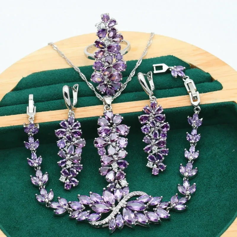 Vintage jewellery set with floral patterns showing necklace, bracelet, earrings and ring in olive green colour